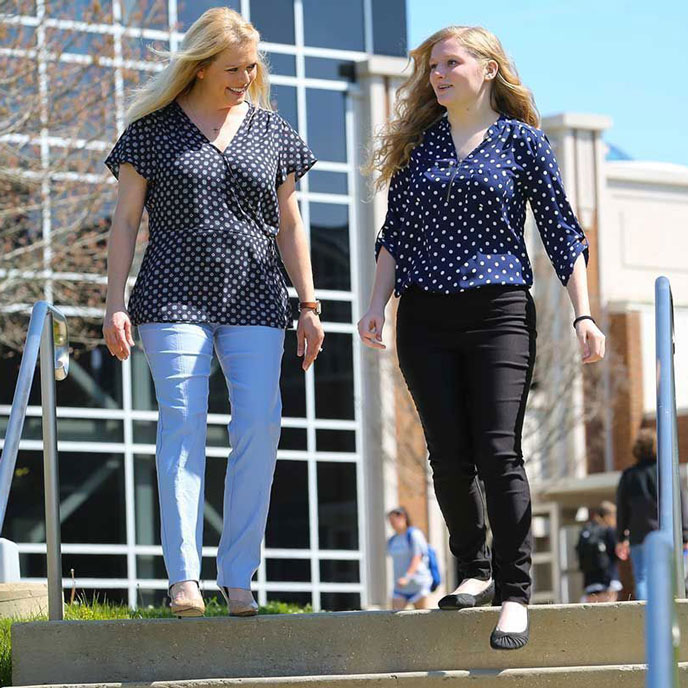 a mother and daughter tour the campus of U A H
