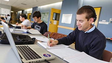 students sitting at a table working on homework