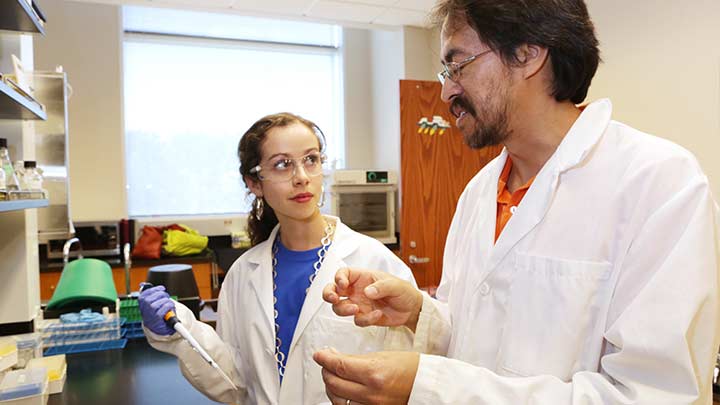 student and professor in a lab