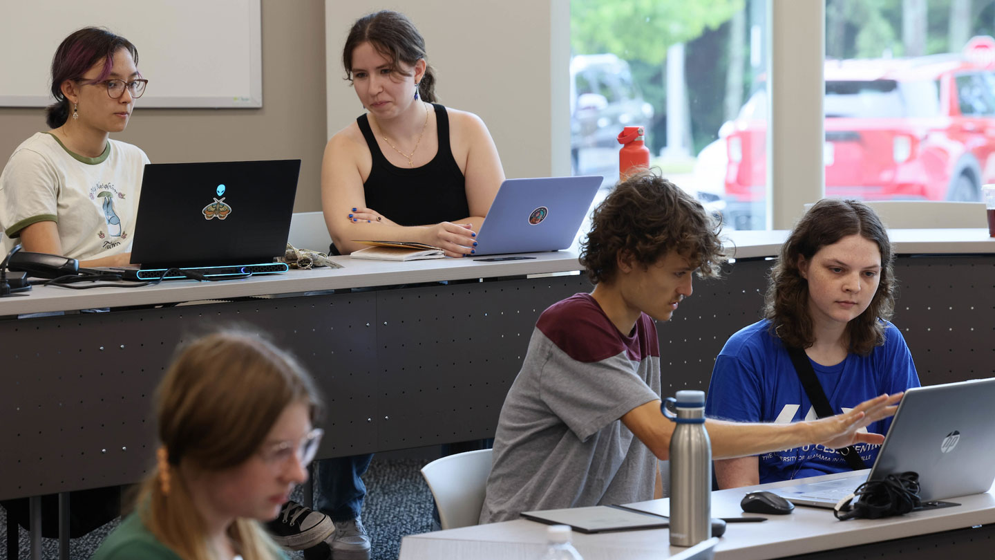 Students help each other work on assignments together