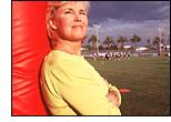 Nanci Kincaid in front of a football field.