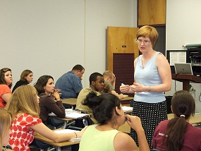 Professor lecturing to students.