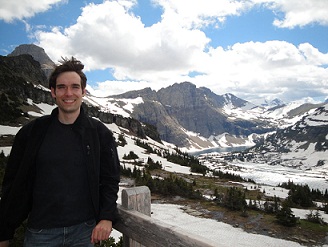 Evan Ragland in front of snowy mountains.