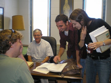 A few students laughing with advisor.