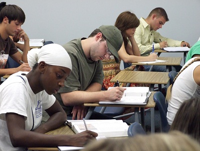 Students writing at their desks.
