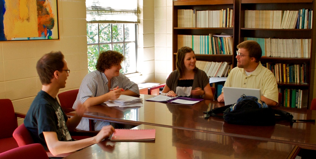 Group of students studying around a table.