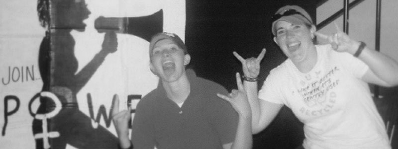 Students in POWER doing "rock on" symbol.