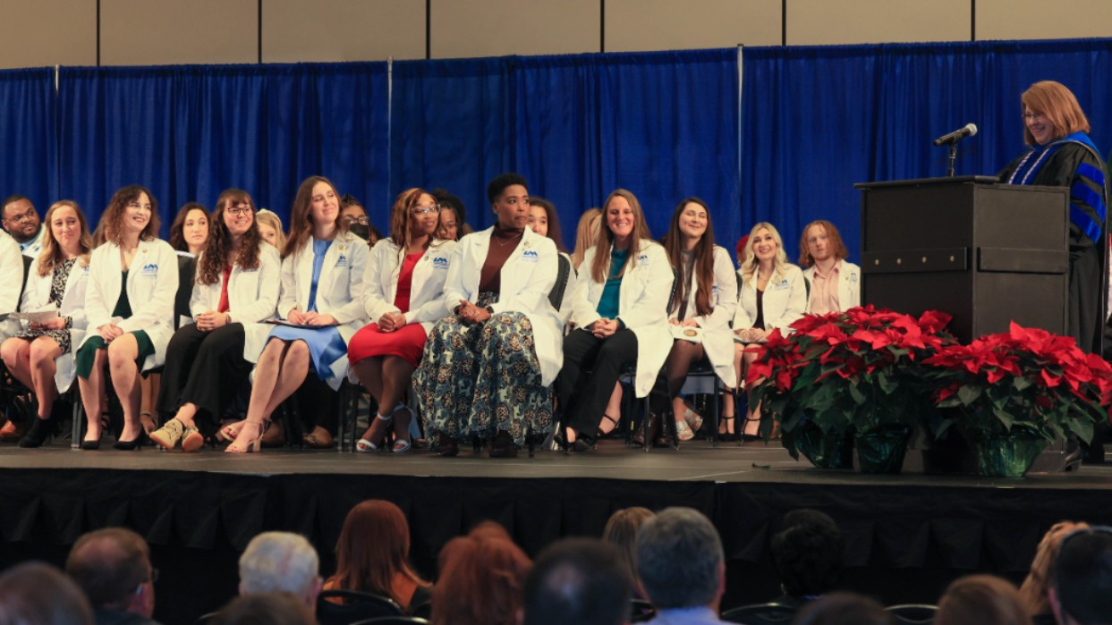 Students receiving their nursing pins at the pinning ceremony.