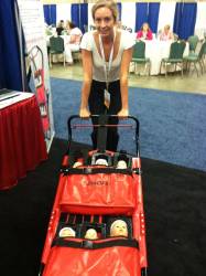 Lydia tries out an infant evacuation cart by Evacu-B
