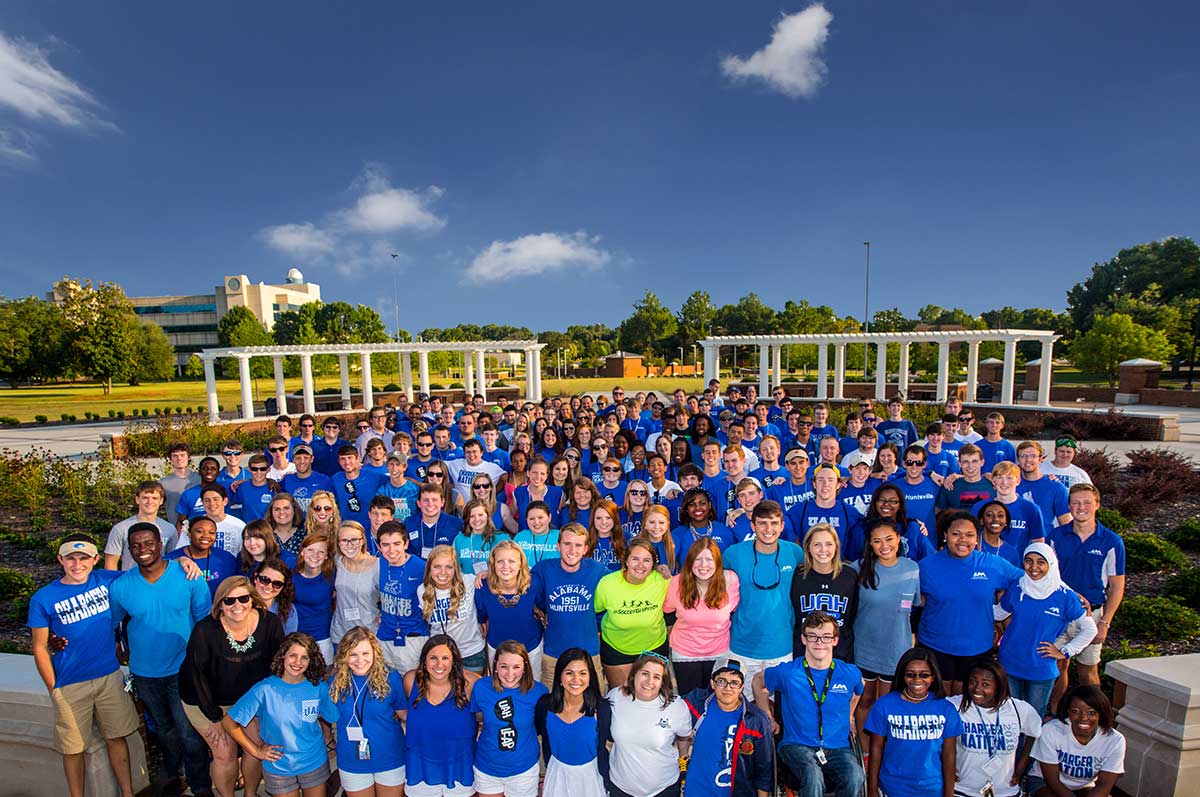 A large group of students in UAH apparel on the greenway