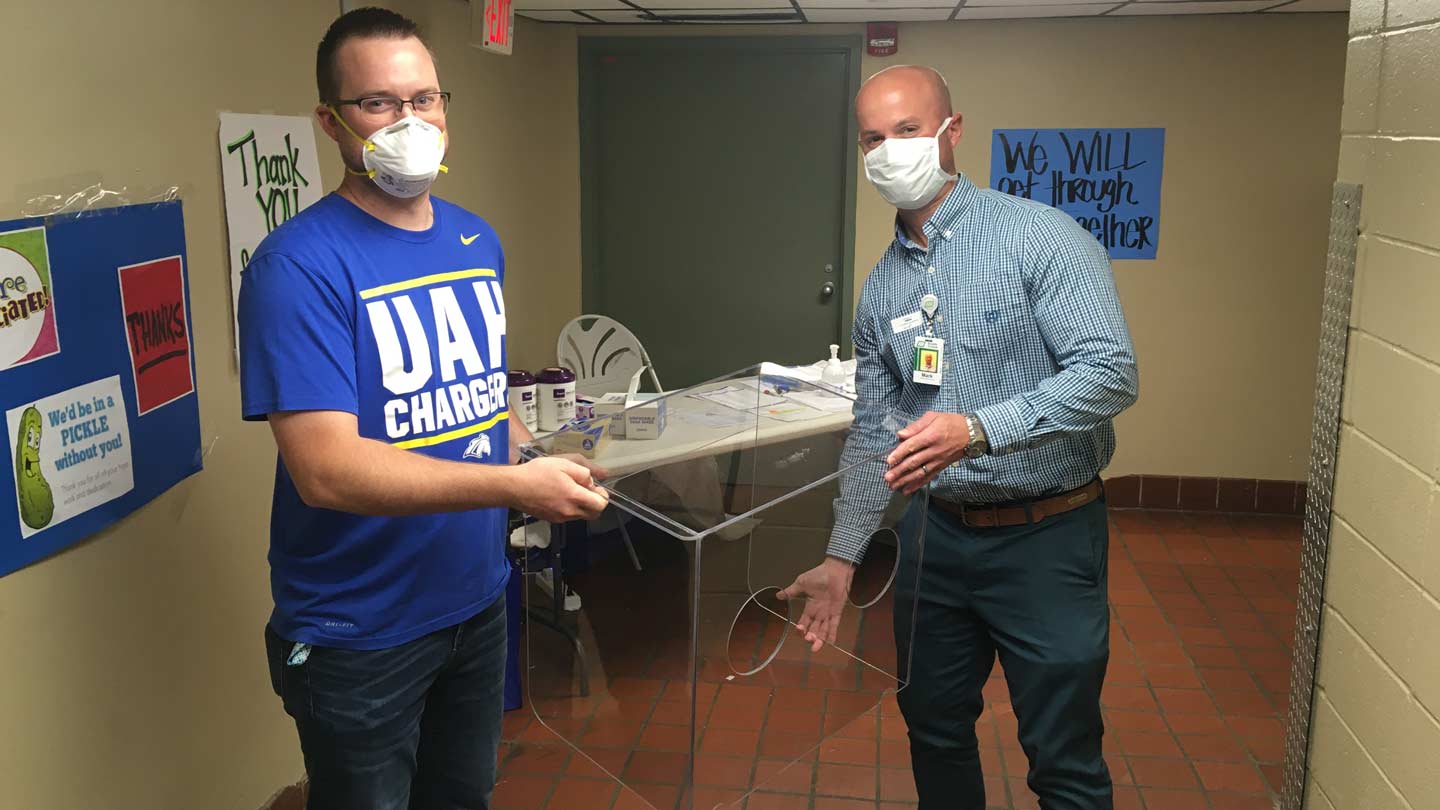 Chris Sallis moves an intubation box with Mark Dunham