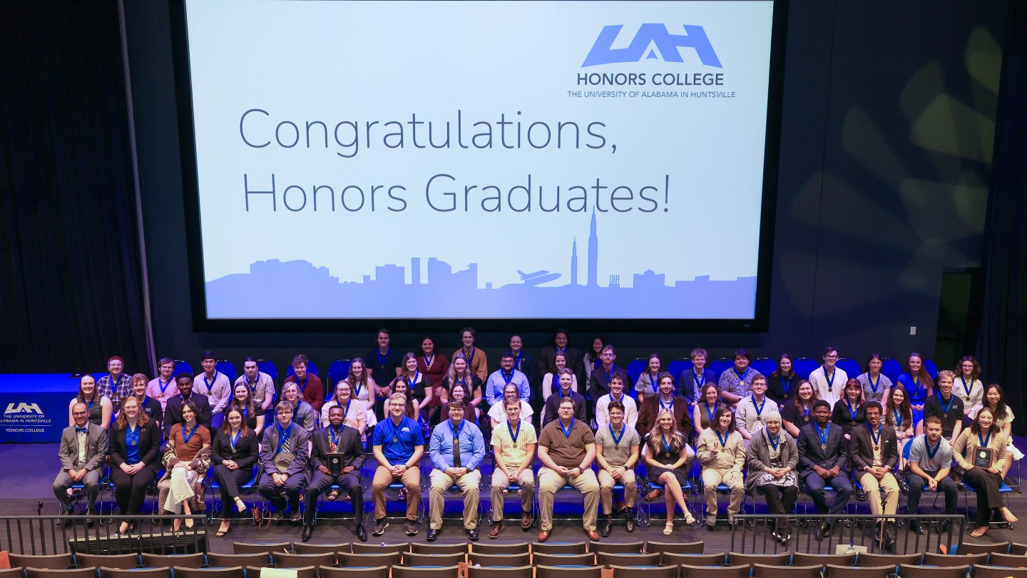 Students from the University of Alabama in Huntsville sitting in chairs in front of a large screen