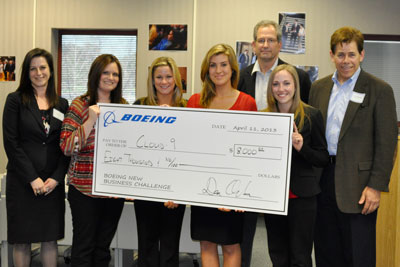 Winning team Cloud 9 receives an $8,000 scholarship check from Boeing executives.