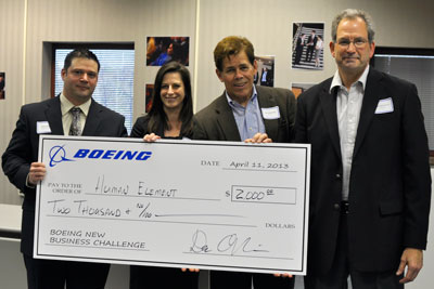 Winning team Human Element receives a $2,000 scholarship check from Boeing executives.