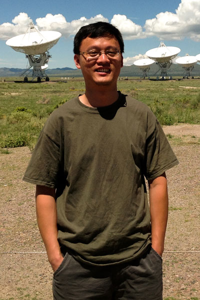 Xiaocan Li near an antenna array in New Mexico.