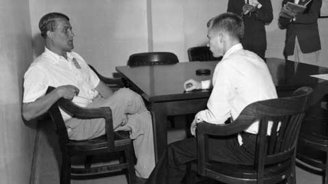 Dr. Wernher von Braun and Jimmy Blackmon talk at Redstone Arsenal as members of the news media look on