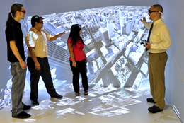 Image of subject standing submerged in the CAVE image of a city