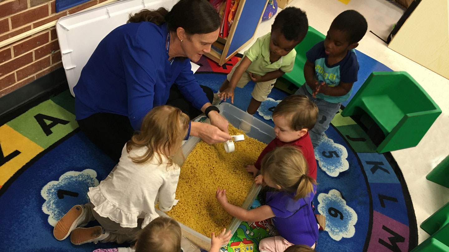 teacher performing a sensory lesson with young students