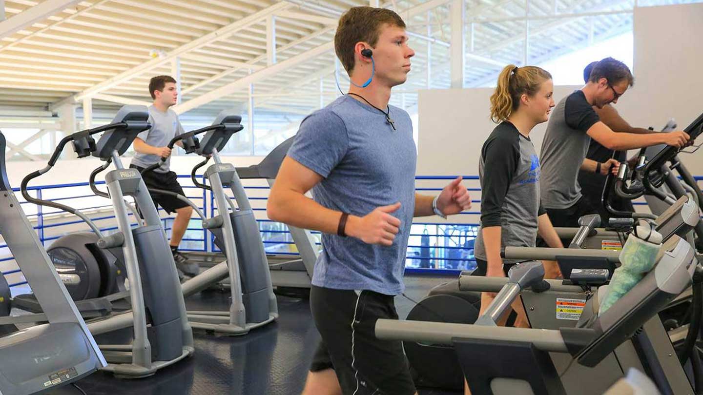 A group of people using fitness equipment.