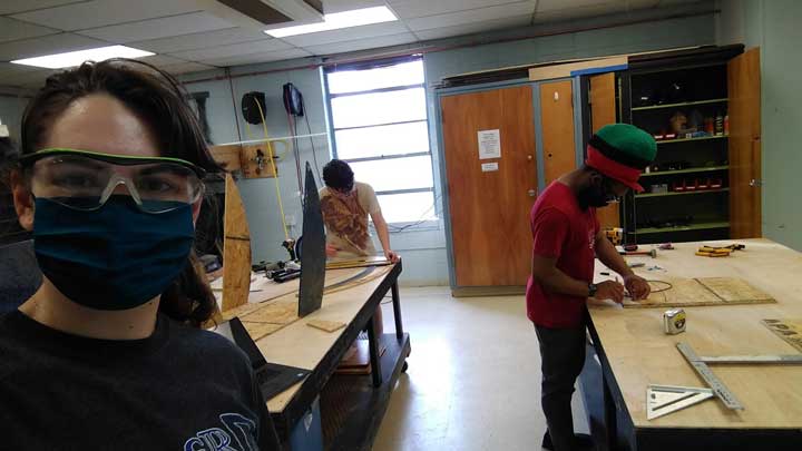 From left, team members Nadia Alexander, Tegan Ruffalo and Jay Hayman build a prototype in the early manufacturing process.