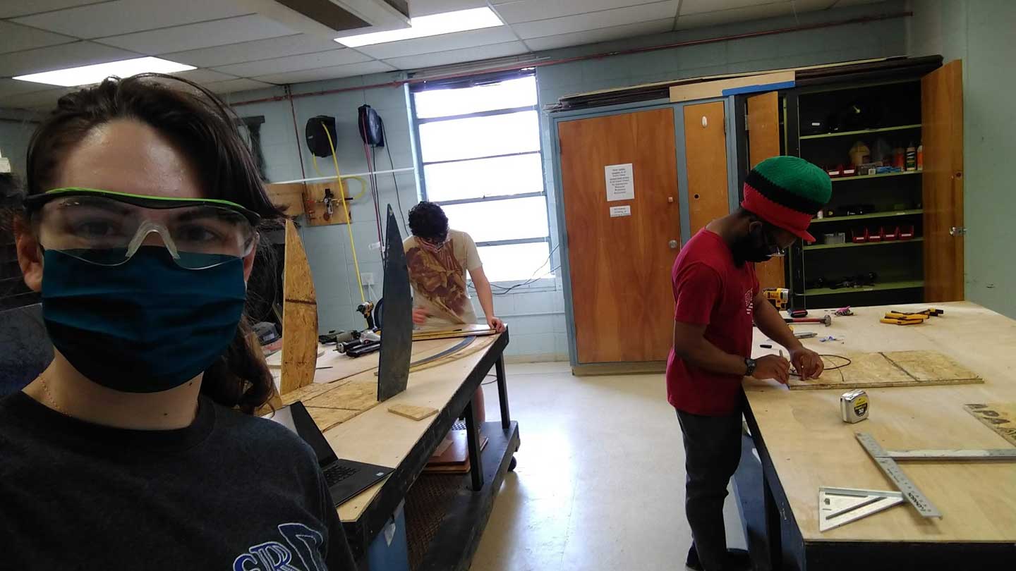 From left, team members Nadia Alexander, Tegan Ruffalo and Jay Hayman build a prototype in the early manufacturing process.