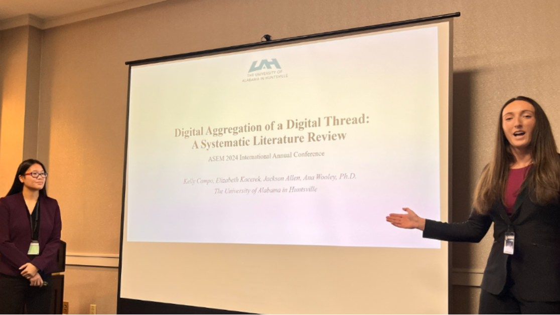 2 students presenting the Literature review in Conference 2024