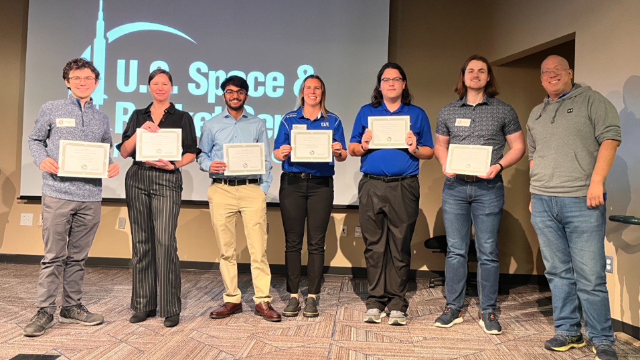 Group of students holding a certificate