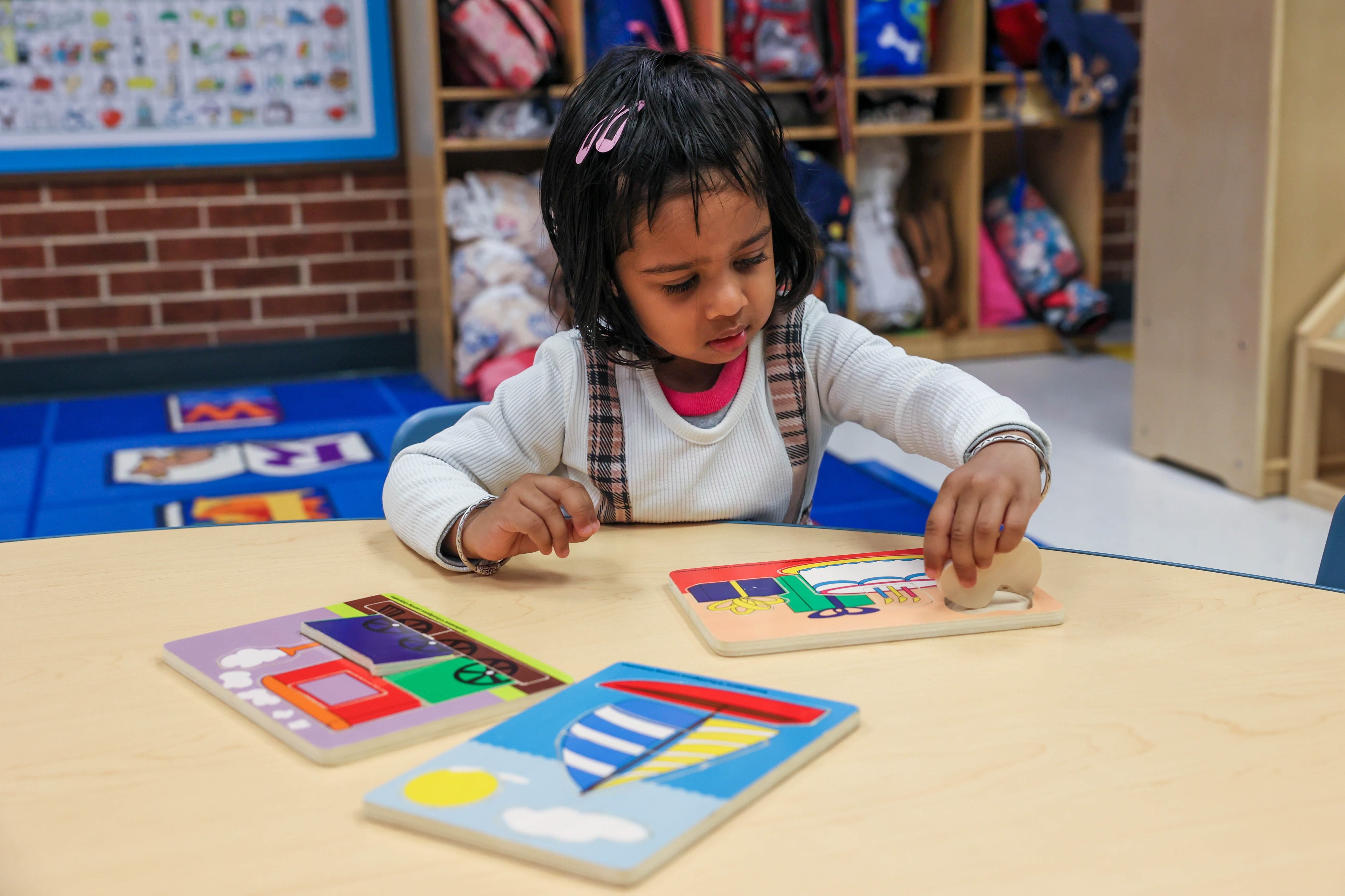 young child working on puzzles