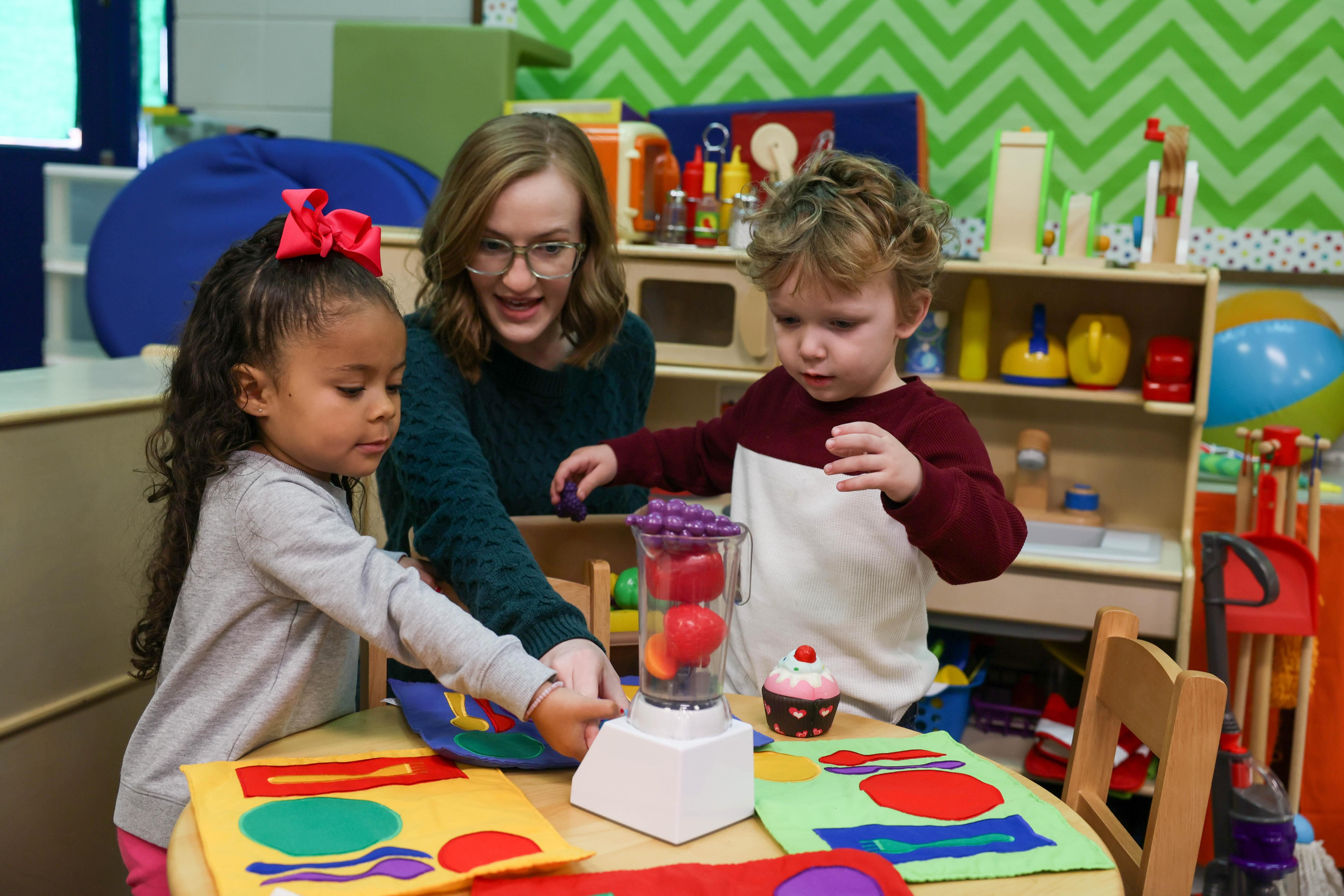 speech therapist with children at play