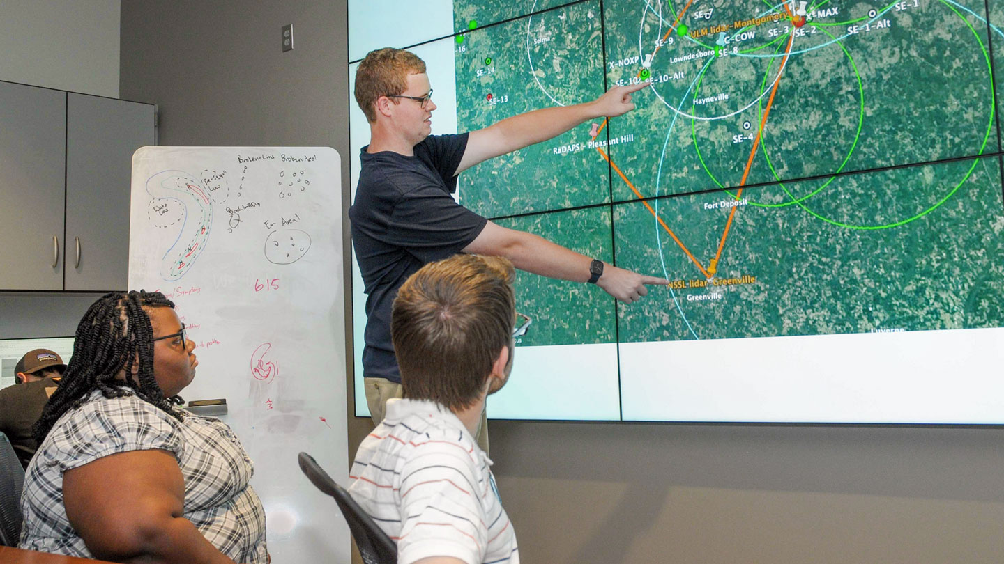 A man gives a presentation on imaging data