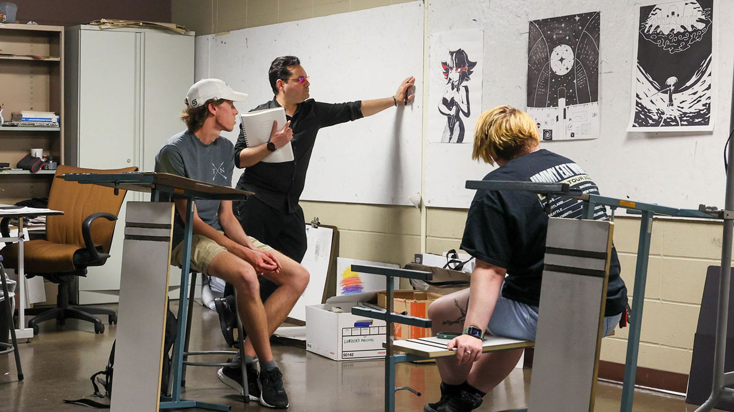 Students examine a fellow students piece of art
