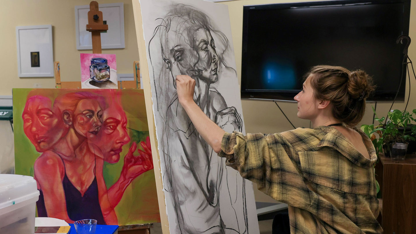 An art student uses charcoal to create beautiful art