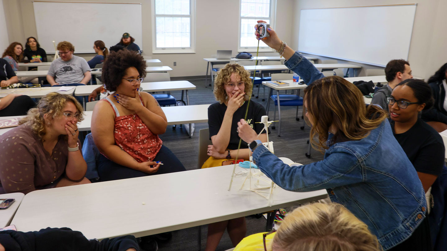 Students work together on a small tower construction project
