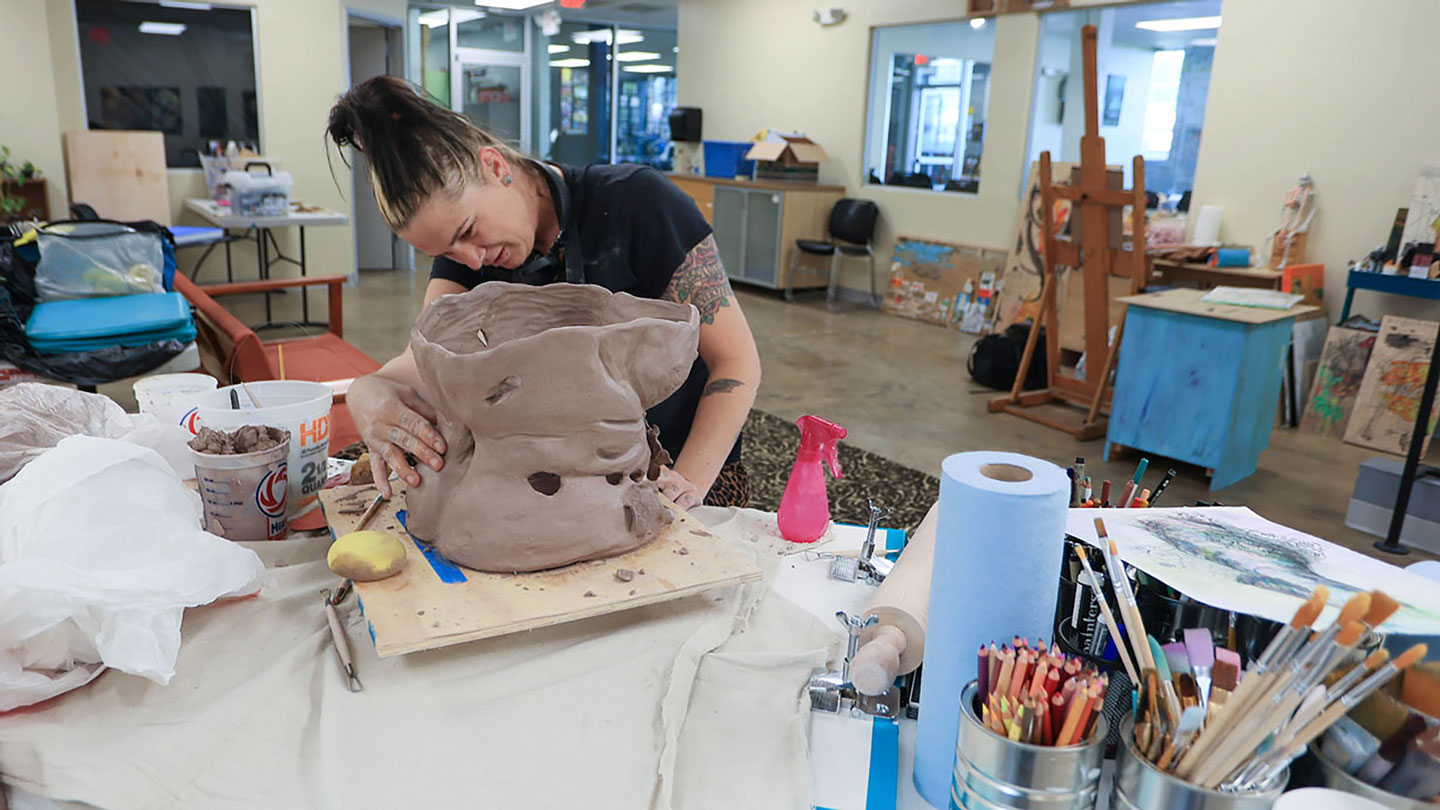 A woman works on a beautiful abstract sculpture