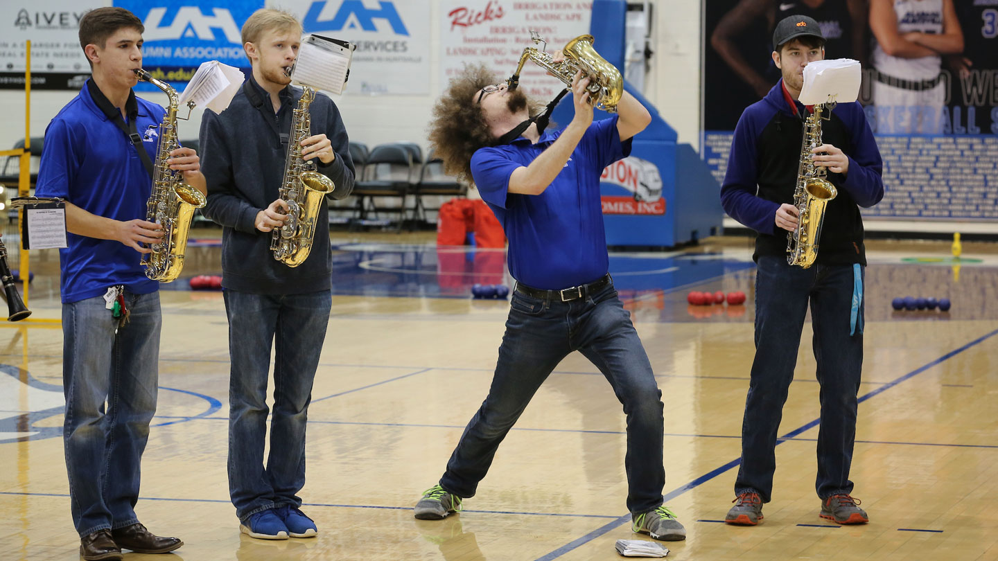 Students passionately play jazz music on saxophones
