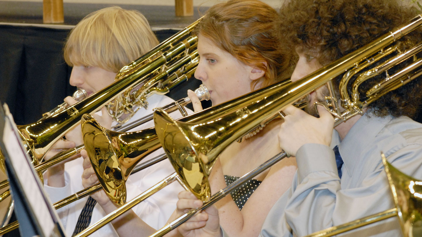 Several students play beautiful music on trombones