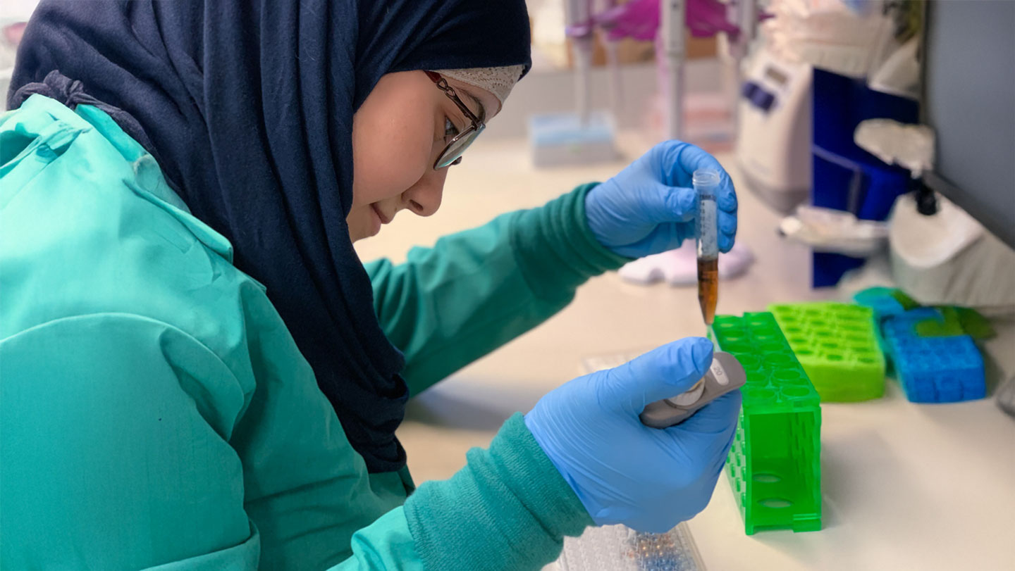 A student examines a test tube in a lab