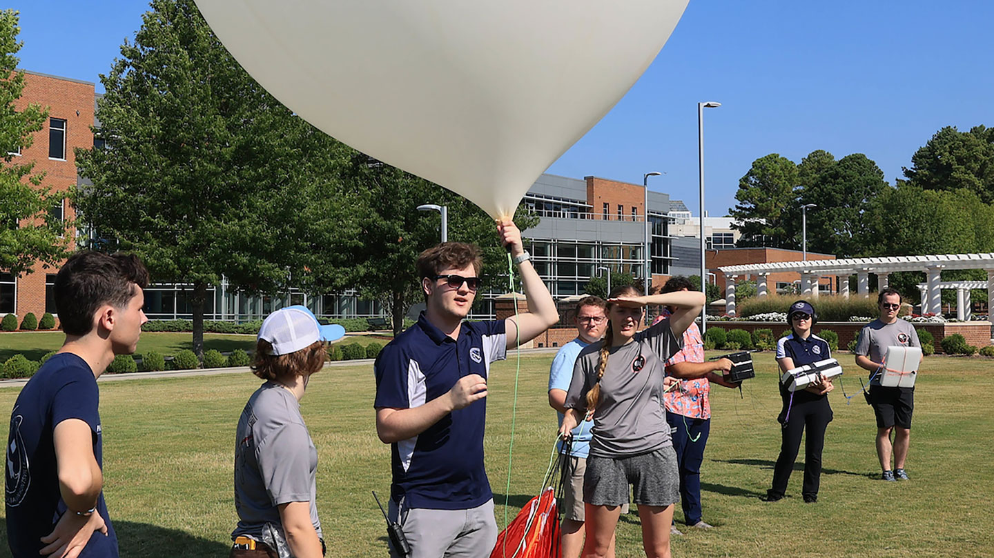 Students use a ballon to collect scientific data
