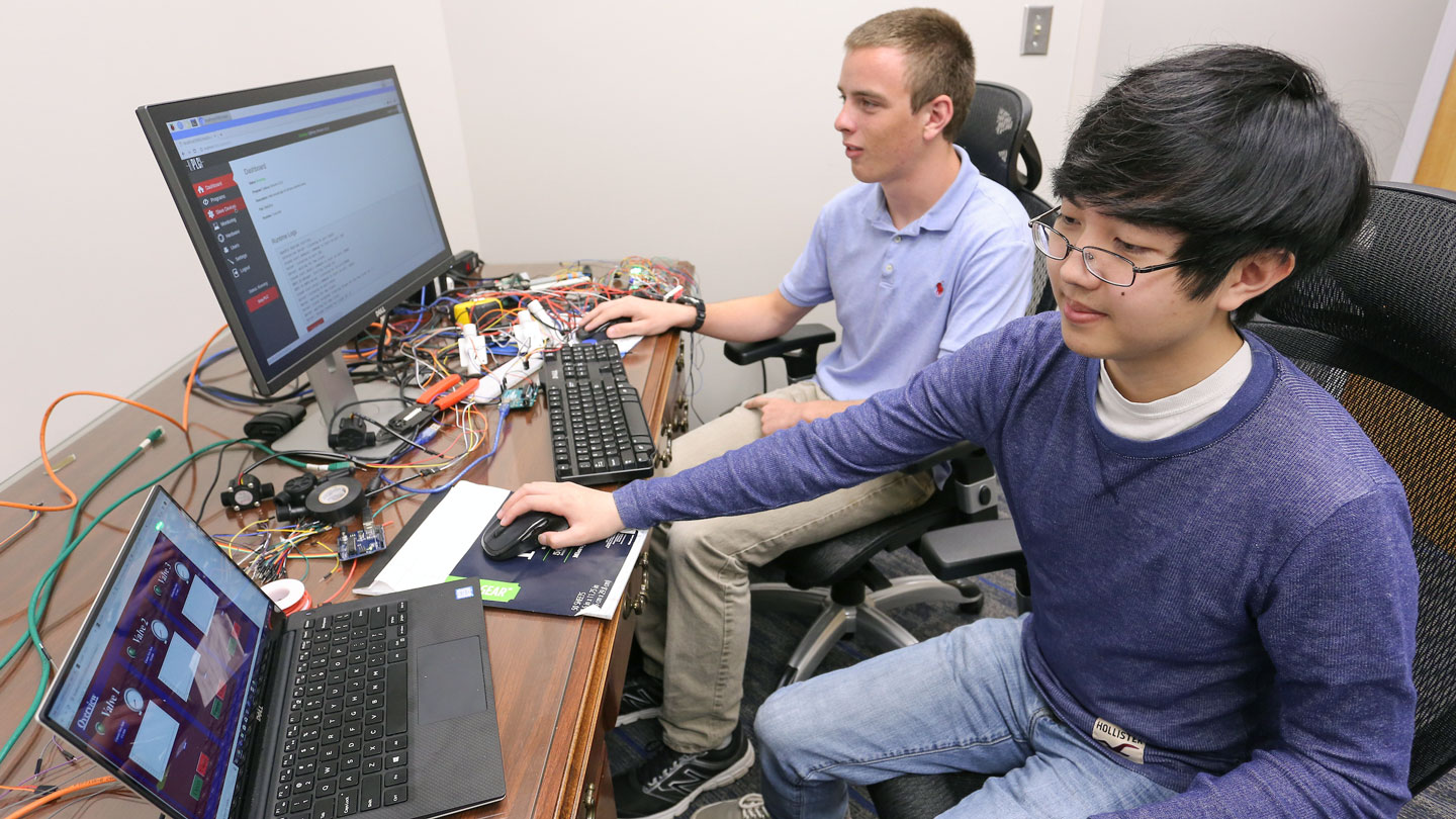 Two computer science majors work together on a program