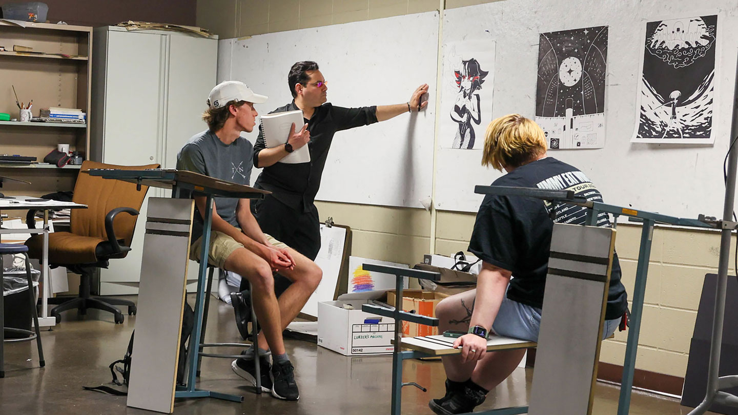 Students examine a fellow students piece of art