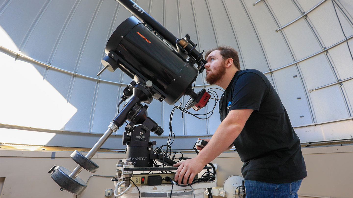 An astronomy uses an advanced telescope