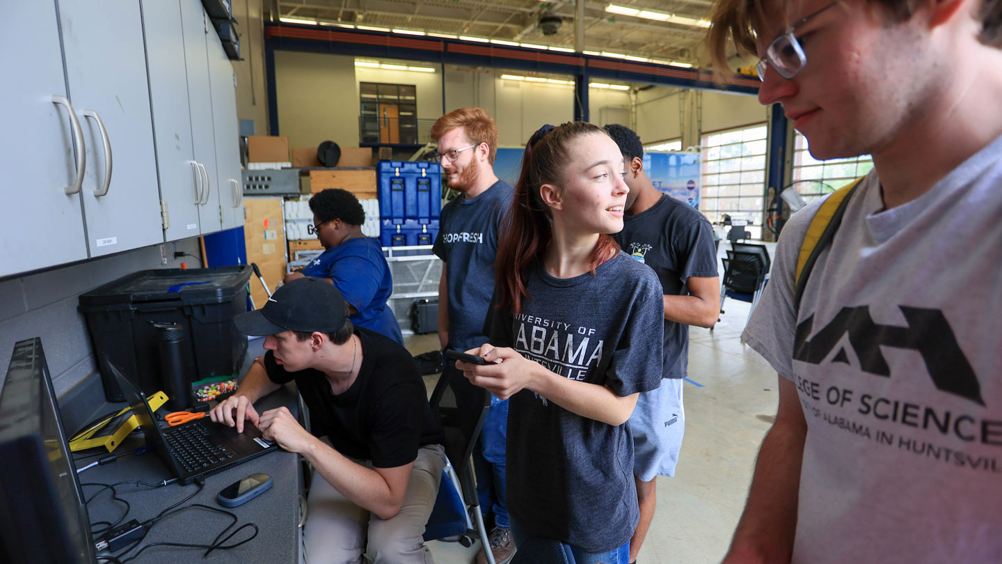 Weather students happily work on weather data collection and analysis