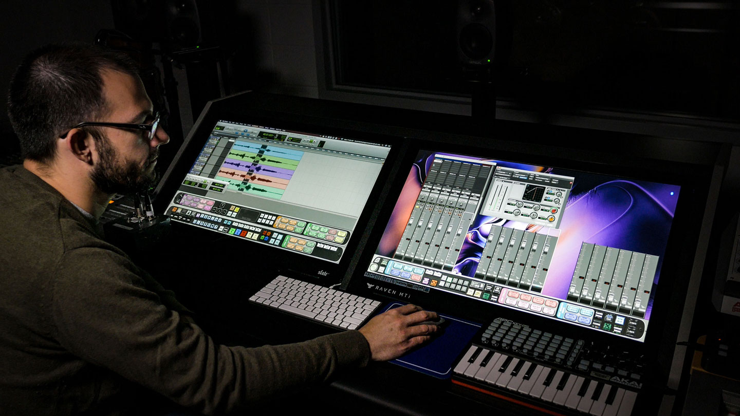 A man operates a soundboard