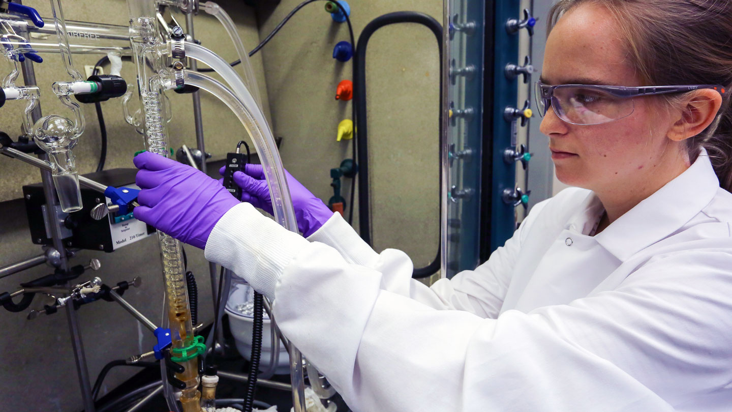 A woman uses complex lab equipment
