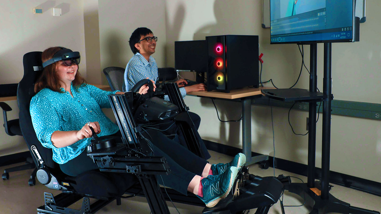 A student enjoys using a driving simulator