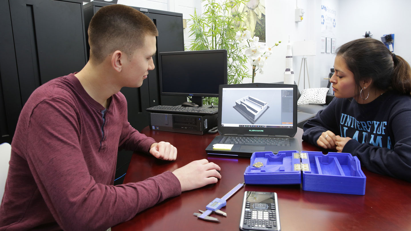 Two students look at a 3D model together