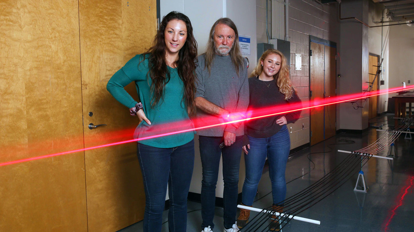 Students observe a laser experiment with great interest
