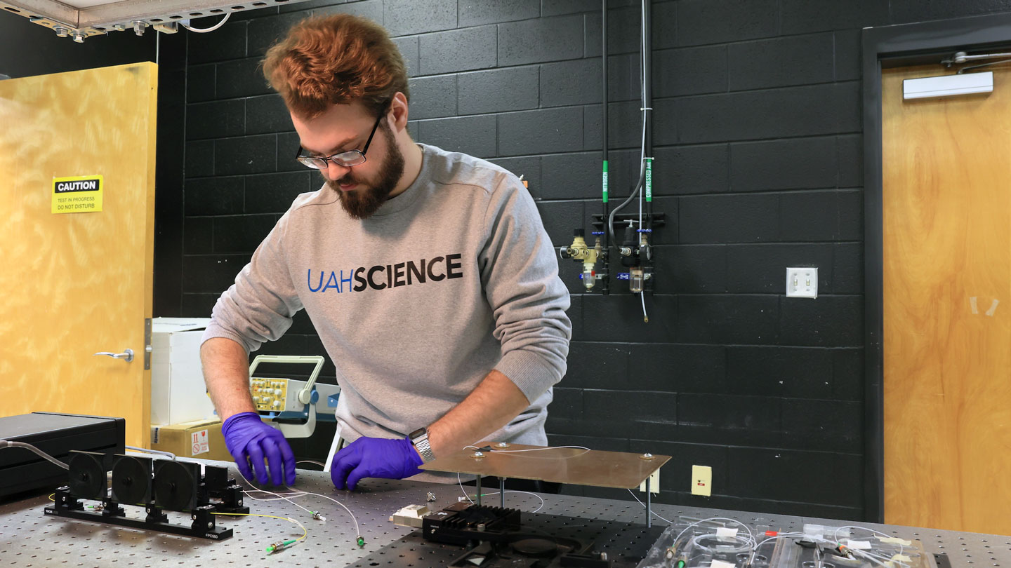A student works on fan wiring for a lab