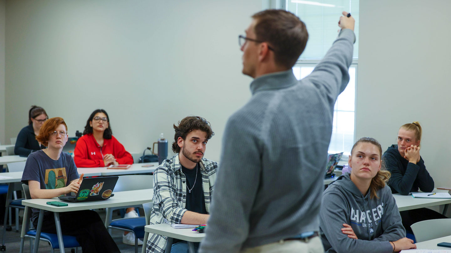 Students listen intently while their instructer gives a lecture