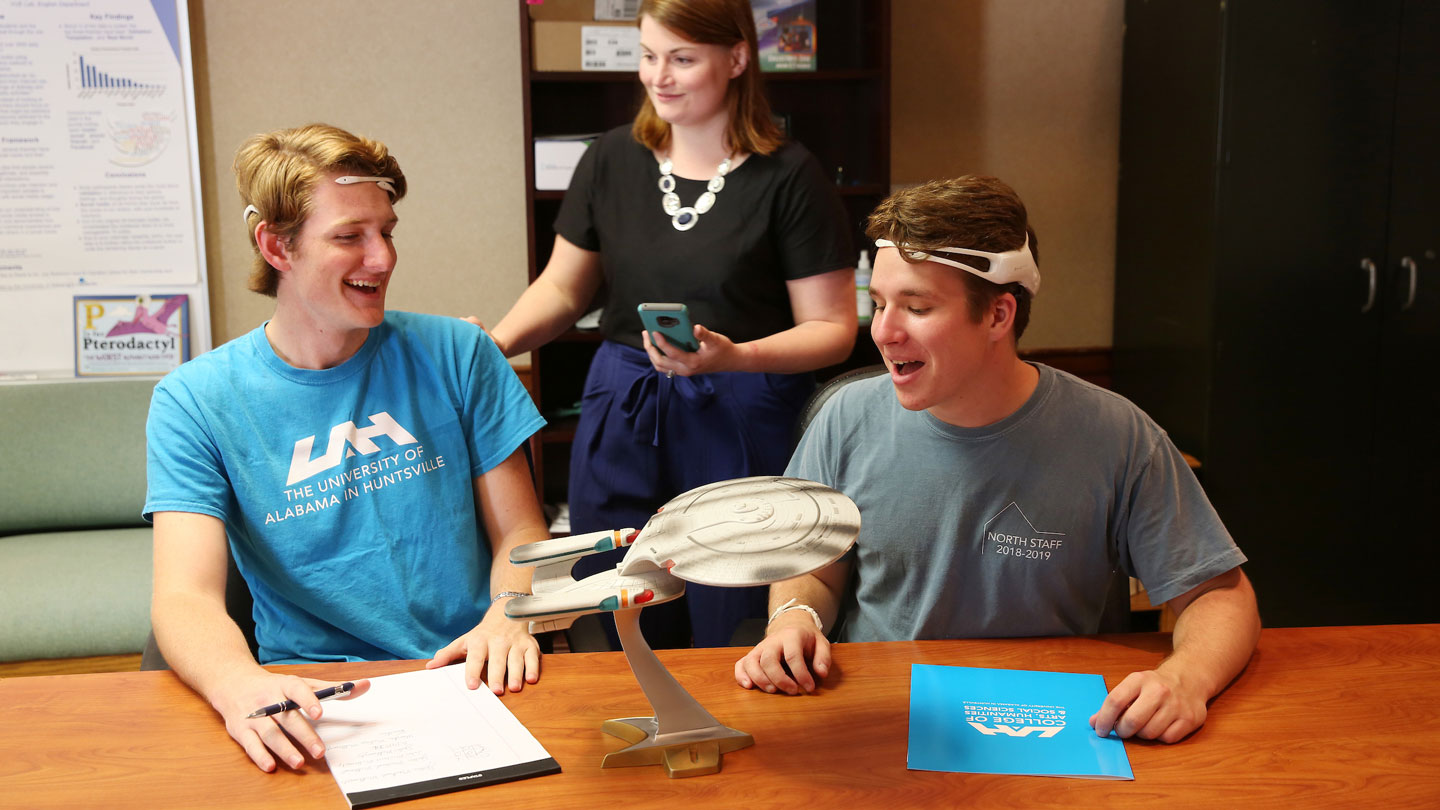 Students stare excitedly at a Star Trek ship model